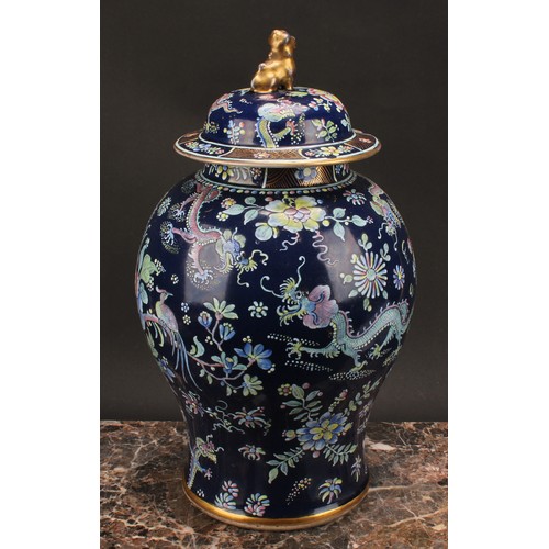 197 - A 19th century Chinese temple jar and cover, decorated in polychrome enamels with dragons amongst fl... 