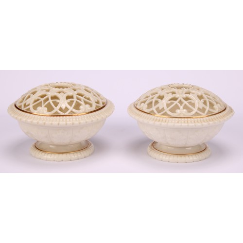 54 - A pair of Graingers Worcester pedestal pot pourri vases, reticulated domed top, gilt lined decoratio... 