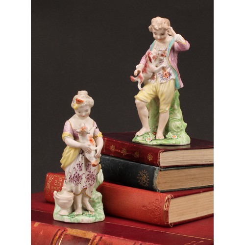 109 - A pair of Derby figures, The French Shepherds, both standing, he with a puppy jumping up his chest, ... 