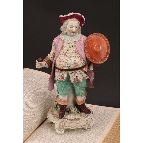 102 - A Derby patch mark figure, Quinn as Sir John Falstaff, he stands holding an oval shield, wearing a b... 