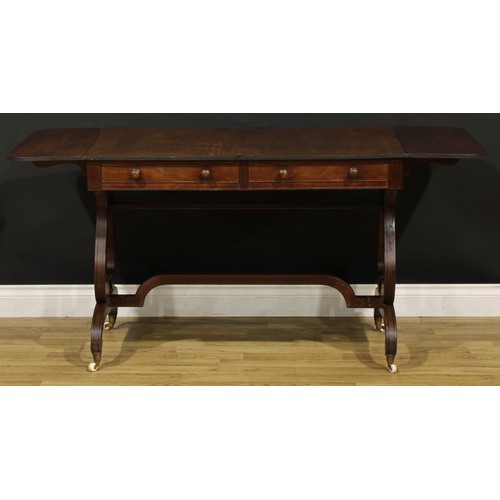 1490 - A 19th century Regency design mahogany sofa table, rounded rectangular top with reeded edge and fall... 