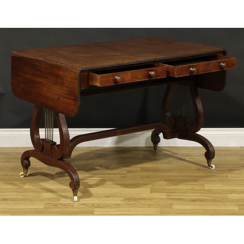 1490 - A 19th century Regency design mahogany sofa table, rounded rectangular top with reeded edge and fall... 