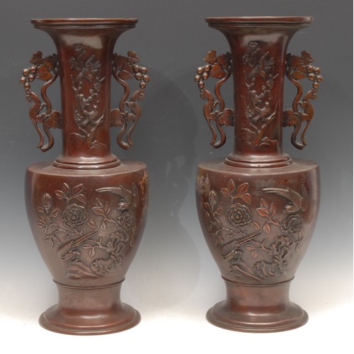 1241 - A pair of large Meiji period Japanese bronze vases, of footed urn form with sleeve necks and applied... 