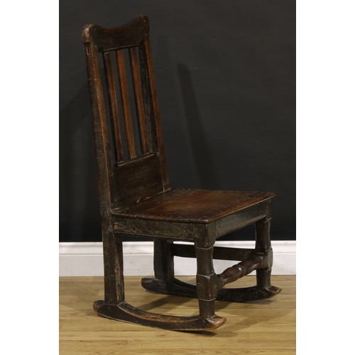 1222 - A Charles II oak side chair, later converted to a rocking chair, plank seat, turned front stretcher,... 