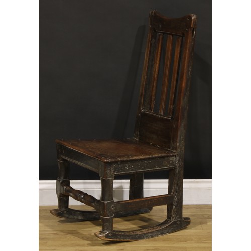 1222 - A Charles II oak side chair, later converted to a rocking chair, plank seat, turned front stretcher,... 