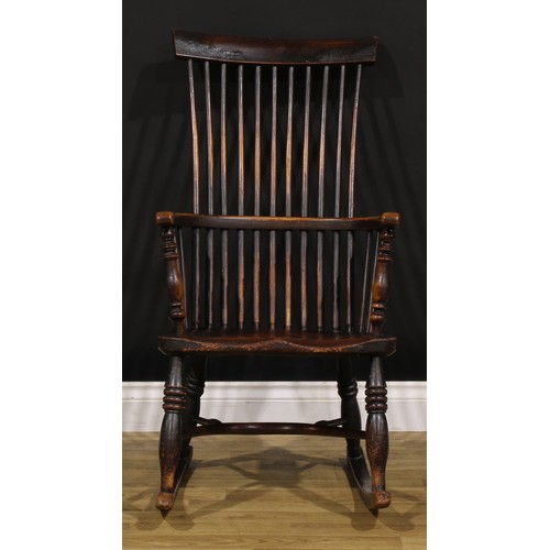 1318 - A 19th century beech, ash and elm comb-back Windsor rocking chair, possibly Scottish, one-piece mid-... 