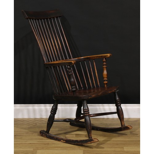 1318 - A 19th century beech, ash and elm comb-back Windsor rocking chair, possibly Scottish, one-piece mid-... 