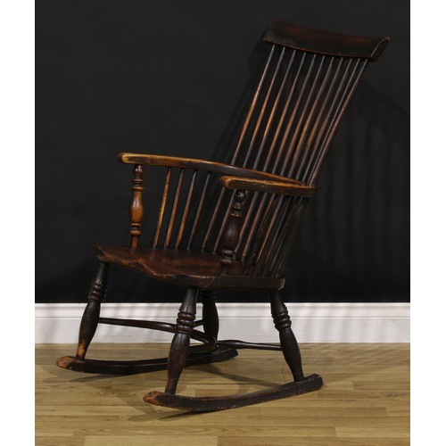 1318 - A 19th century beech, ash and elm comb-back Windsor rocking chair, possibly Scottish, one-piece mid-... 