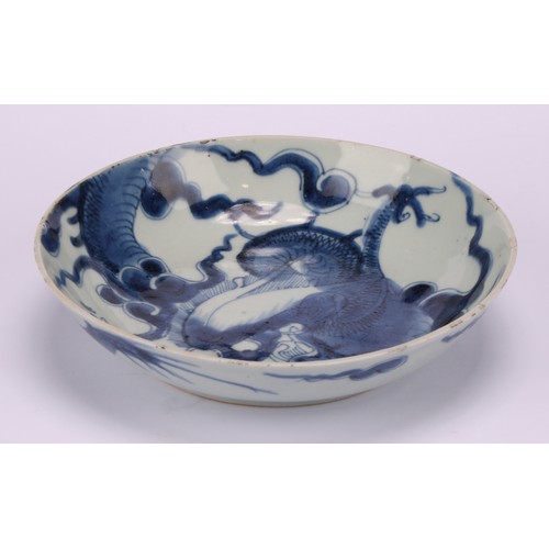 228 - A Chinese Yong Zheng period blue and white bowl, decorated with dragons in tones of underglaze blue,... 