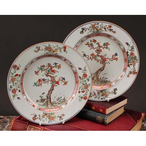 190 - A pair of Chinese famille verte porcelain plates, the central well painted with cherry blossom and b... 