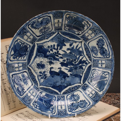 193 - A 17th century Chinese Kraak porcelain dish, the central well painted in tones of underglaze blue wi... 