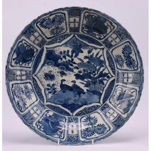 193 - A 17th century Chinese Kraak porcelain dish, the central well painted in tones of underglaze blue wi... 