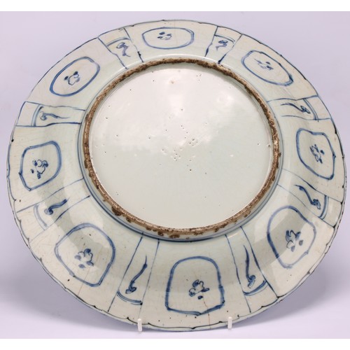 193 - A 17th century Chinese Kraak porcelain dish, the central well painted in tones of underglaze blue wi... 