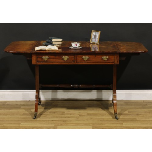 1426 - A Regency mahogany sofa table, rounded rectangular top with fall leaves above a pair of frieze drawe... 