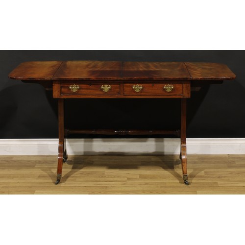 1426 - A Regency mahogany sofa table, rounded rectangular top with fall leaves above a pair of frieze drawe... 