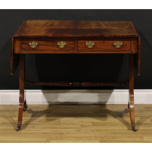 1426 - A Regency mahogany sofa table, rounded rectangular top with fall leaves above a pair of frieze drawe... 