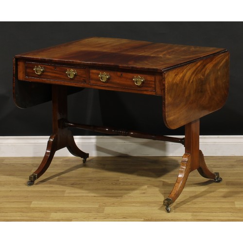 1426 - A Regency mahogany sofa table, rounded rectangular top with fall leaves above a pair of frieze drawe... 