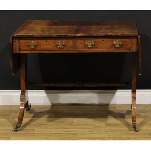 1426 - A Regency mahogany sofa table, rounded rectangular top with fall leaves above a pair of frieze drawe... 