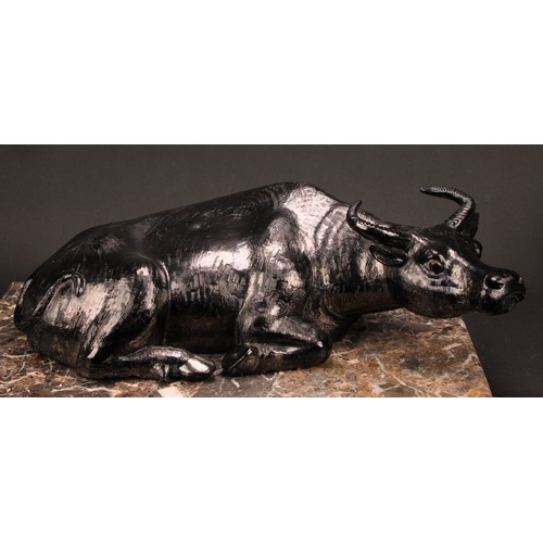 224 - A Chinese silvery-black glazed porcellaneous model, of a recumbent water buffalo, 17cm high, 54cm wi... 