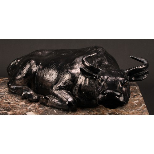 224 - A Chinese silvery-black glazed porcellaneous model, of a recumbent water buffalo, 17cm high, 54cm wi... 