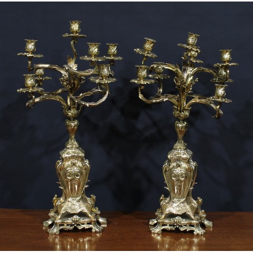 1370 - A pair of large Rococo Revival gilt metal eight-light candelabra, cast throughout with scrolling aca... 