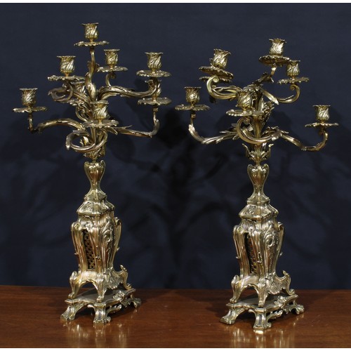 1370 - A pair of large Rococo Revival gilt metal eight-light candelabra, cast throughout with scrolling aca... 