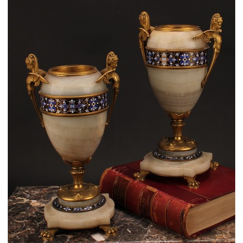 1243 - A pair of late 19th century French gilt bronze and champlevé enamel mounted onyx ovoid urns, the han... 