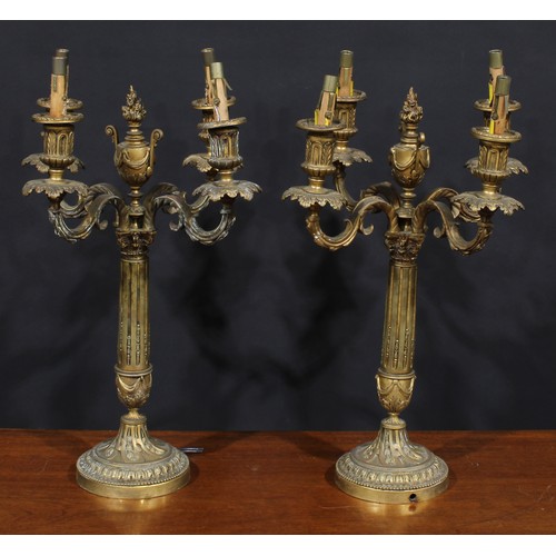 1372 - A pair of Louis XVI Revival ormolu four-light candelabra, each stop-fluted pillar surmounted by a fl... 