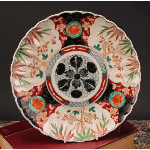 242 - A Japanese shaped circular dish, decorated in the Imari palette, 31.5cm diameter, Meiji period