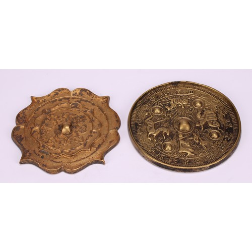 214 - A Chinese bronze lotus shaped hand mirror, 10cm wide; another (2)