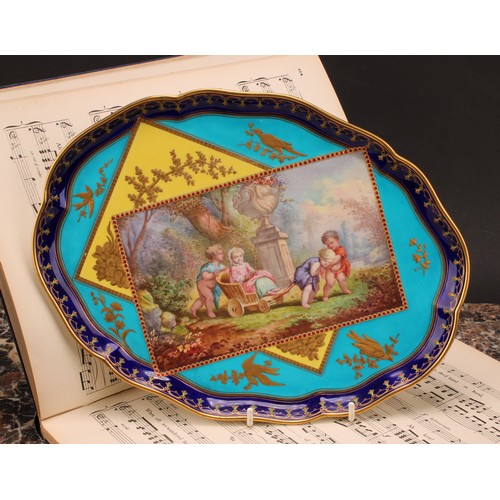 133 - A French porcelain shaped oval cabaret tray, painted with children at play in an Italianate garden, ... 