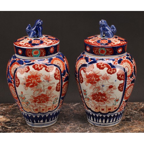 268 - A pair of Japanese ovoid jars and covers, decorated in the Imari palette, 32cm high, Meiji period