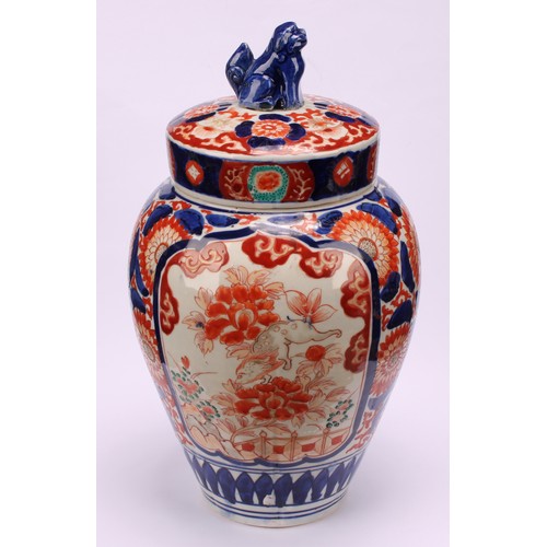 268 - A pair of Japanese ovoid jars and covers, decorated in the Imari palette, 32cm high, Meiji period