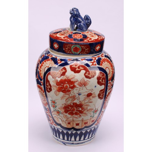 268 - A pair of Japanese ovoid jars and covers, decorated in the Imari palette, 32cm high, Meiji period