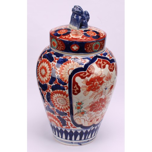 268 - A pair of Japanese ovoid jars and covers, decorated in the Imari palette, 32cm high, Meiji period