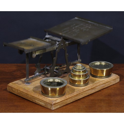 1298 - A set of Victorian oak and brass parcel post letter balance scales, the larger plateau inscribed wit... 