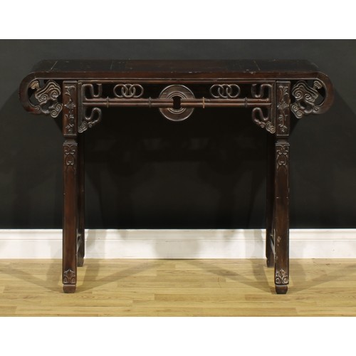 1227 - A Chinese hardwood altar table, rectangular top with scroll ends terminating in stylised clouds, the... 