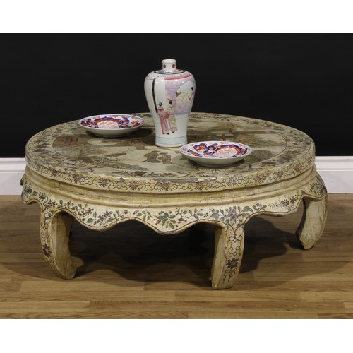 1224 - A Chinese export low table, circular top decorated with figures in a pagoda landscape on an off-whit... 