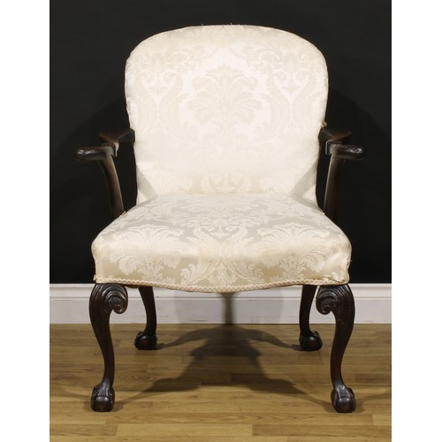 1238 - A George II Revival mahogany elbow chair, stuffed-over upholstery, outswept arms and cabriole legs c... 