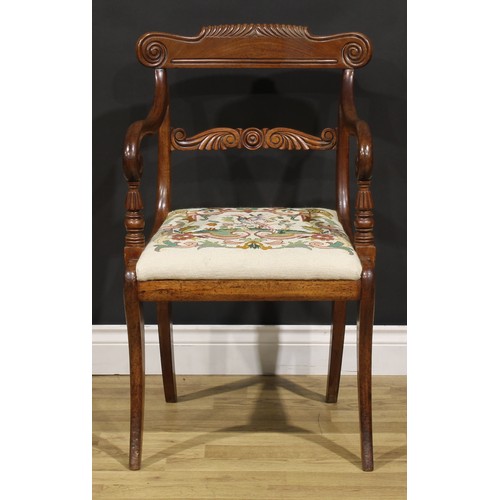 1413 - A George IV mahogany desk chair or elbow chair, parcel-gadrooned cresting rail carved with scrolls, ... 