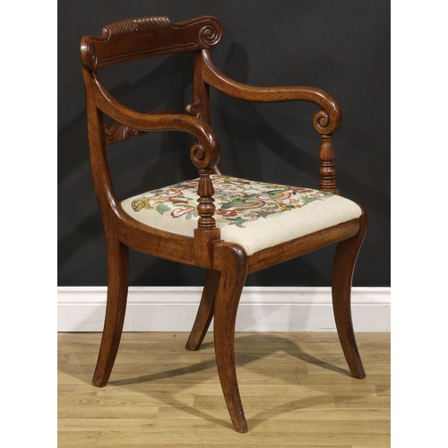 1413 - A George IV mahogany desk chair or elbow chair, parcel-gadrooned cresting rail carved with scrolls, ... 