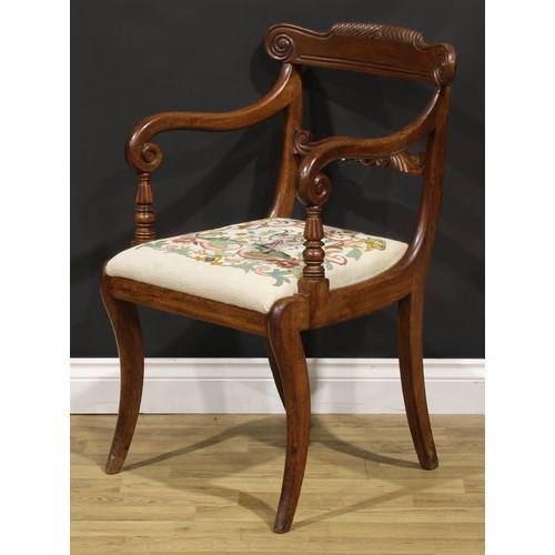 1413 - A George IV mahogany desk chair or elbow chair, parcel-gadrooned cresting rail carved with scrolls, ... 