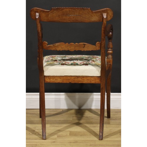 1413 - A George IV mahogany desk chair or elbow chair, parcel-gadrooned cresting rail carved with scrolls, ... 