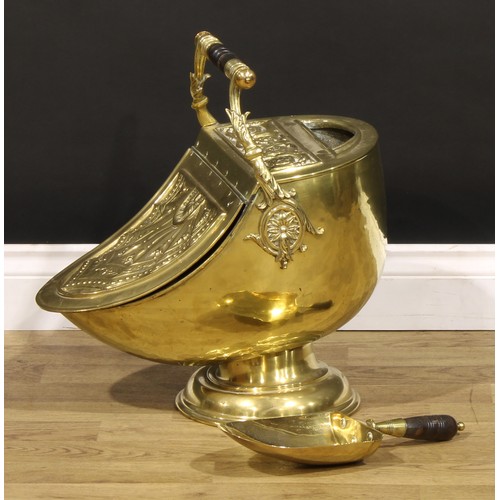 1285 - An Edwardian brass helmet shaped coal scuttle, embossed in the Neoclassical taste, 57cm high overall... 