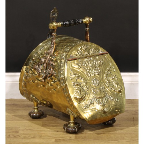 1284 - An Aesthetic Movement period brass and copper coal scuttle, turned ebony handle terminating in Art N... 