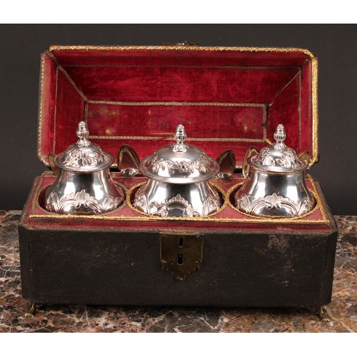 560 - A set of three George II Old Sheffield Plate ogee pedestal tea caddies, each chased in the rococo ta... 