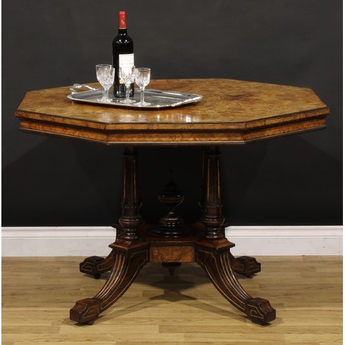 1868 - A Victorian walnut centre table, octagonal top, turned and fluted columns centred by a spire finial,... 