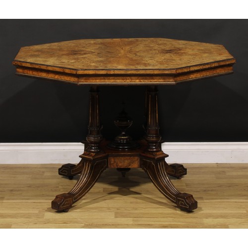 1868 - A Victorian walnut centre table, octagonal top, turned and fluted columns centred by a spire finial,... 