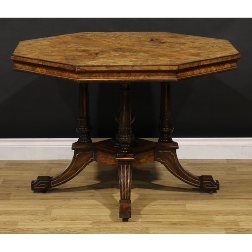 1868 - A Victorian walnut centre table, octagonal top, turned and fluted columns centred by a spire finial,... 