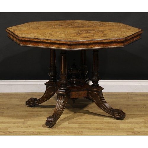 1868 - A Victorian walnut centre table, octagonal top, turned and fluted columns centred by a spire finial,... 